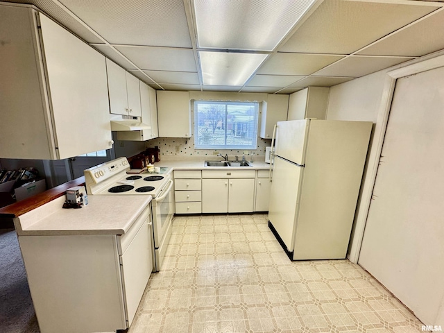 1107 E Cleveland St, West Frankfort, IL 62896 - kitchen with white appliances, a sink, light countertops, under cabinet range hood, and a paneled ceiling