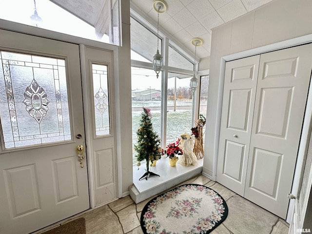 foyer featuring a wealth of natural light and vaulted ceiling