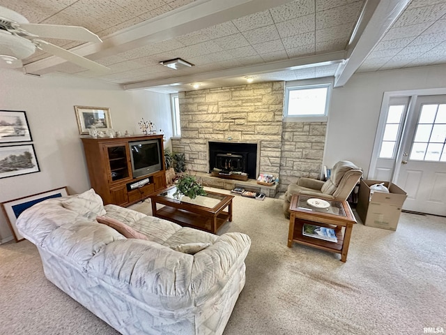 carpeted living room featuring beam ceiling