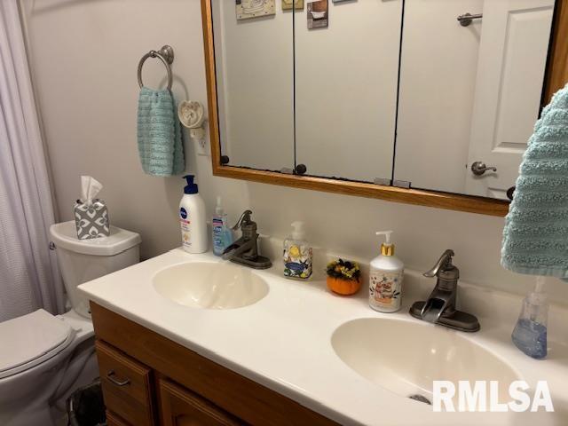 bathroom with vanity and toilet