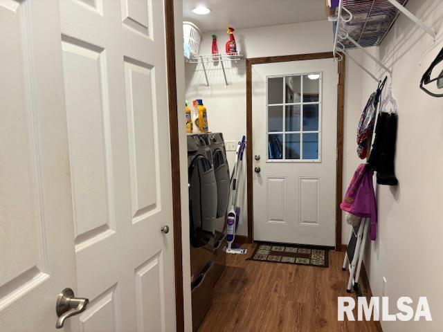 interior space with hardwood / wood-style floors and washing machine and clothes dryer