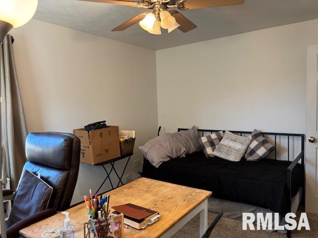 living room with ceiling fan and carpet floors