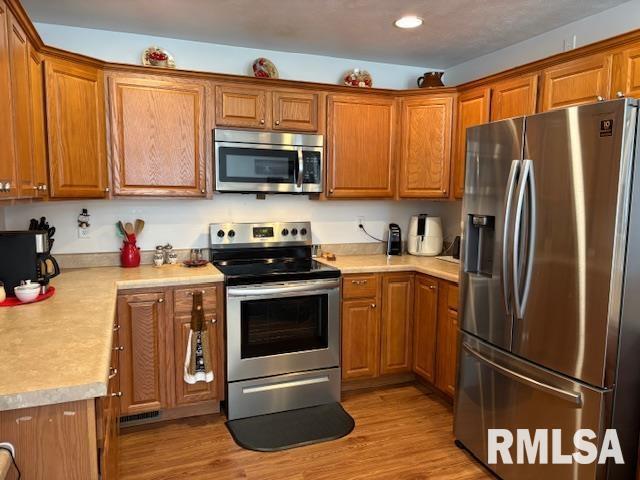 kitchen featuring light hardwood / wood-style floors and stainless steel appliances