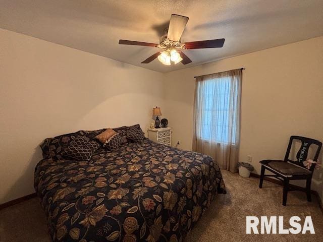 bedroom featuring ceiling fan and carpet