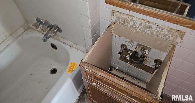 bathroom with a washtub and sink