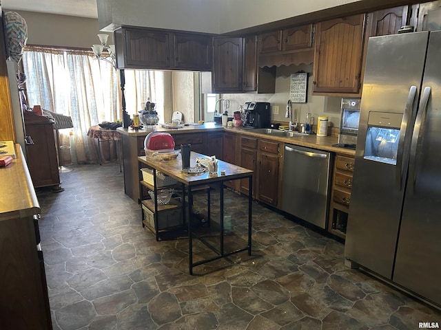 kitchen featuring dark brown cabinets, stainless steel appliances, and sink