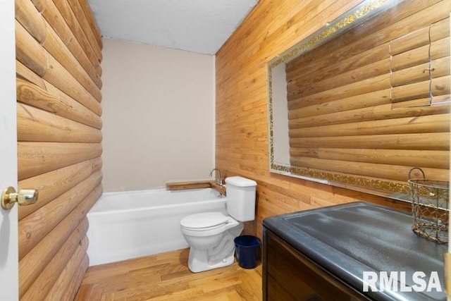 bathroom featuring a tub to relax in, log walls, wood-type flooring, and toilet