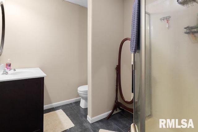 bathroom with walk in shower, tile patterned flooring, vanity, and toilet