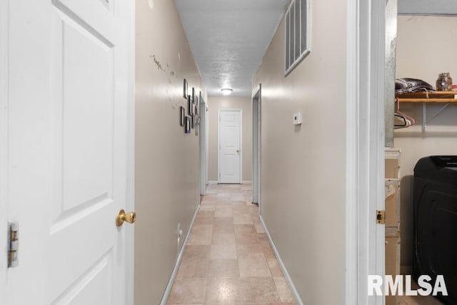 corridor with washer / clothes dryer