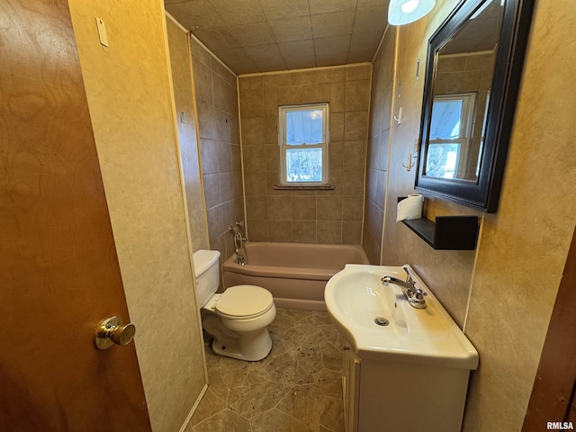 full bathroom featuring tiled shower / bath, tile patterned flooring, vanity, and toilet