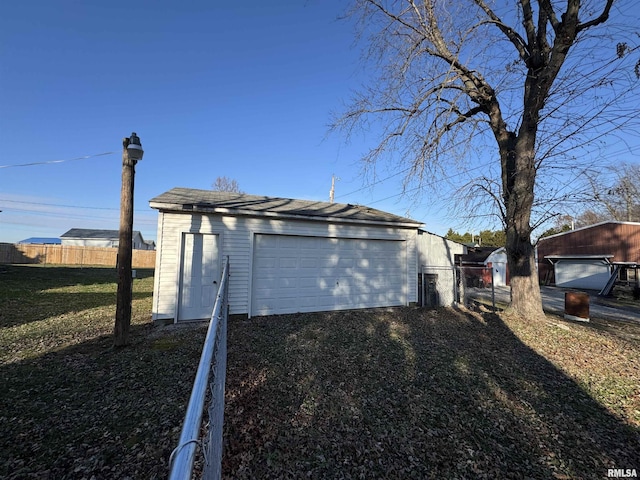 view of side of home with an outdoor structure and a garage