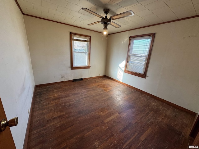 empty room featuring ceiling fan, crown molding, and dark hardwood / wood-style floors