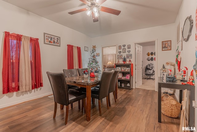 dining room with ceiling fan and hardwood / wood-style floors