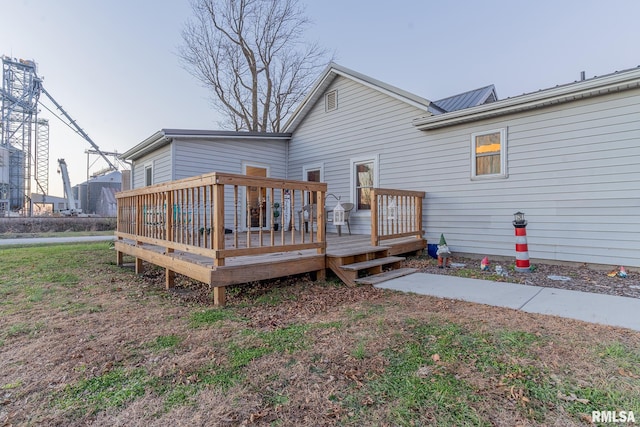 rear view of property featuring a wooden deck