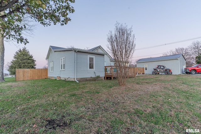 view of side of home with a lawn and a wooden deck