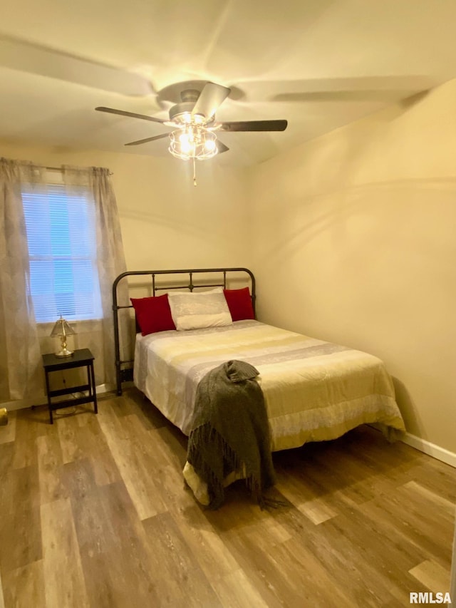 bedroom featuring ceiling fan and wood-type flooring