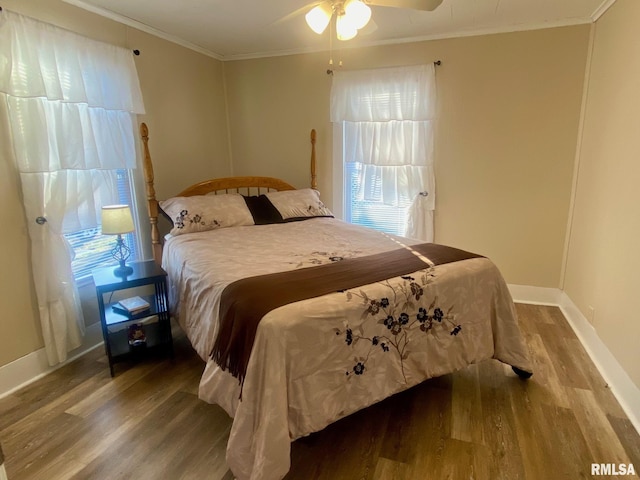 bedroom with hardwood / wood-style floors, multiple windows, crown molding, and ceiling fan