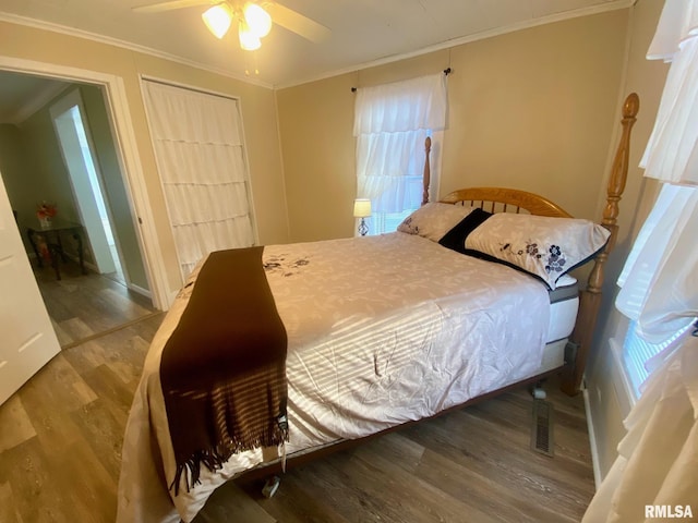 bedroom with hardwood / wood-style floors, ceiling fan, and ornamental molding