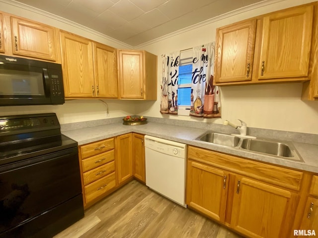 kitchen with crown molding, sink, black appliances, and light wood-type flooring