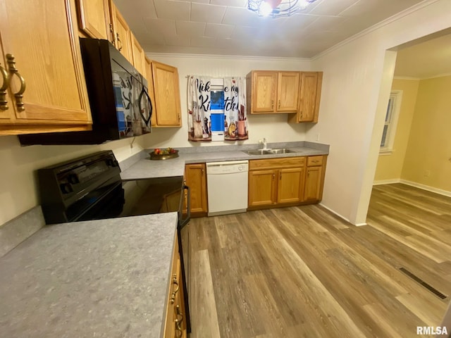 kitchen featuring crown molding, light hardwood / wood-style flooring, black appliances, and sink