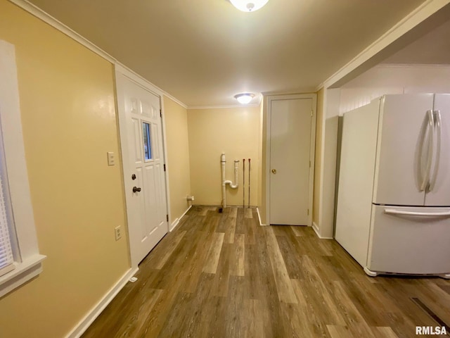 hall with crown molding and wood-type flooring