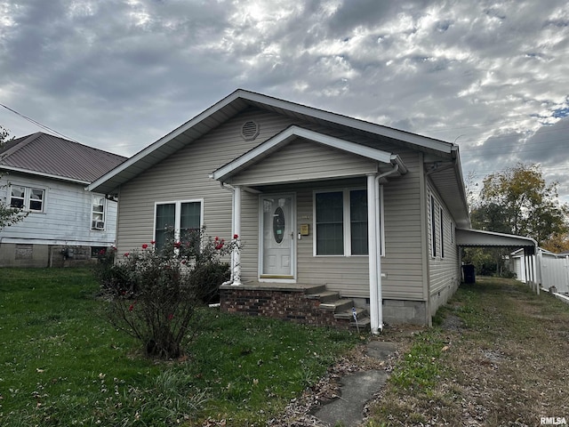 view of front of house with a front yard and a carport