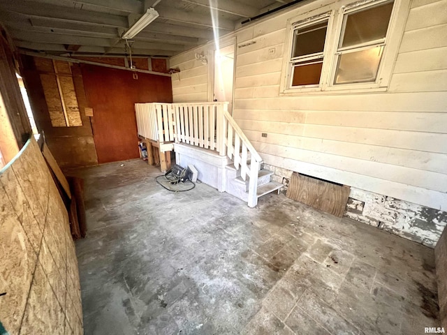 basement featuring wood walls