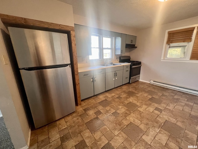 kitchen with gray cabinetry, sink, stainless steel appliances, and a baseboard heating unit