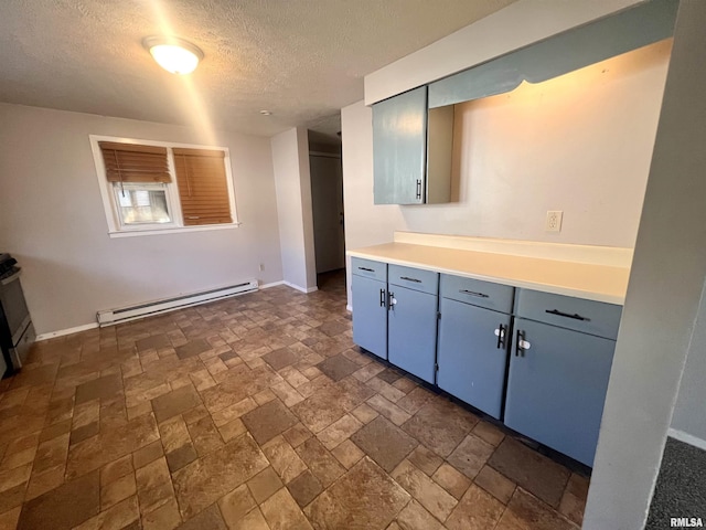 kitchen with baseboard heating and a textured ceiling