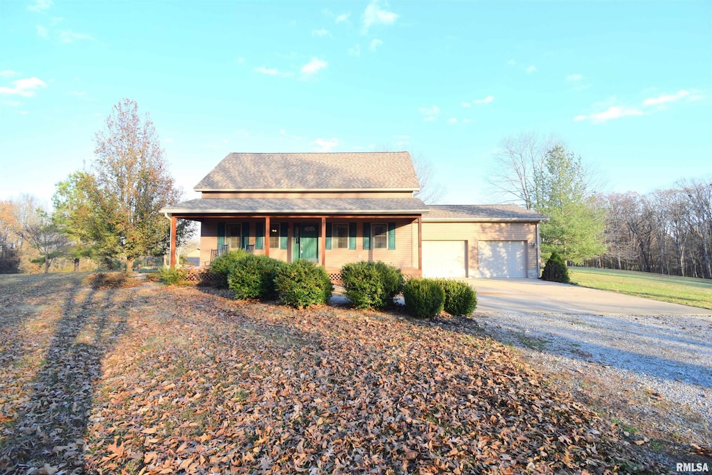 view of front of home with a porch and a garage