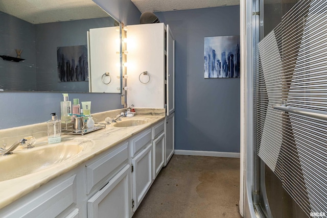 bathroom with vanity and a textured ceiling