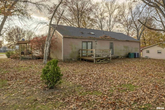 back of house featuring a wooden deck and central AC