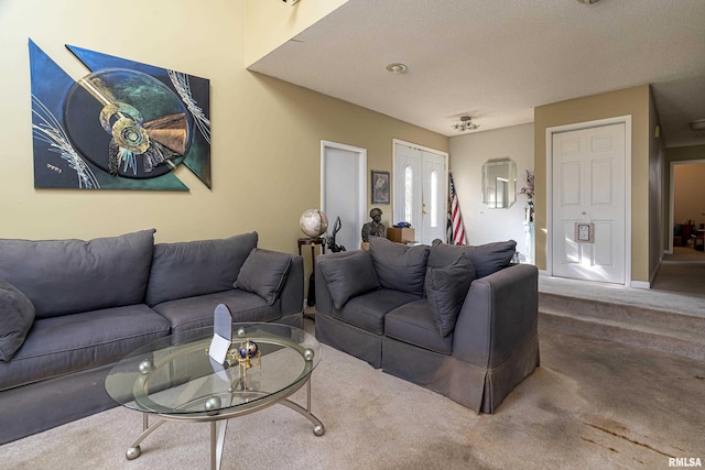 living room featuring carpet floors and a textured ceiling