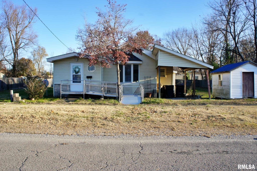 view of front facade with a shed and a carport