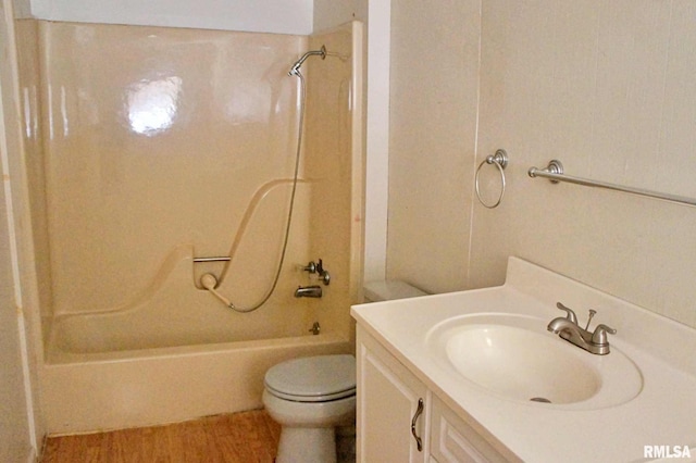 full bathroom featuring vanity, hardwood / wood-style flooring, toilet, and shower / bathtub combination