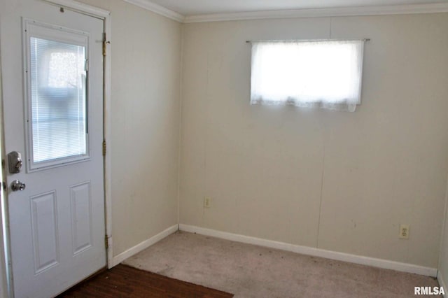 doorway with dark carpet and ornamental molding