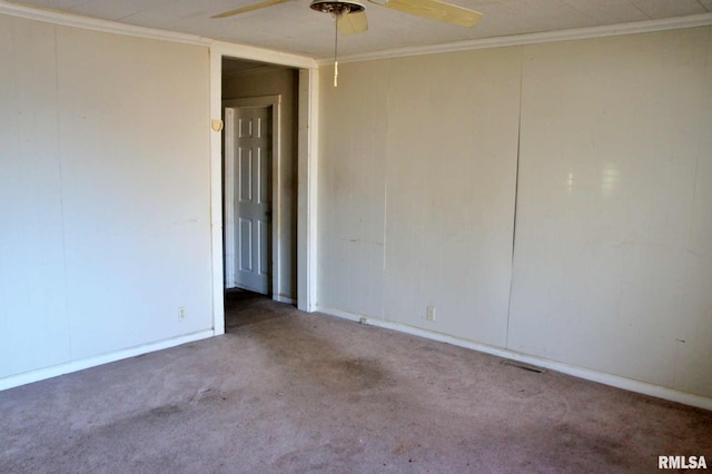 empty room featuring carpet, ceiling fan, and ornamental molding