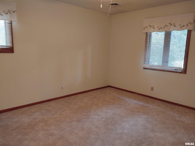 unfurnished room featuring carpet floors and a healthy amount of sunlight