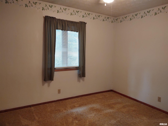 carpeted empty room with a textured ceiling