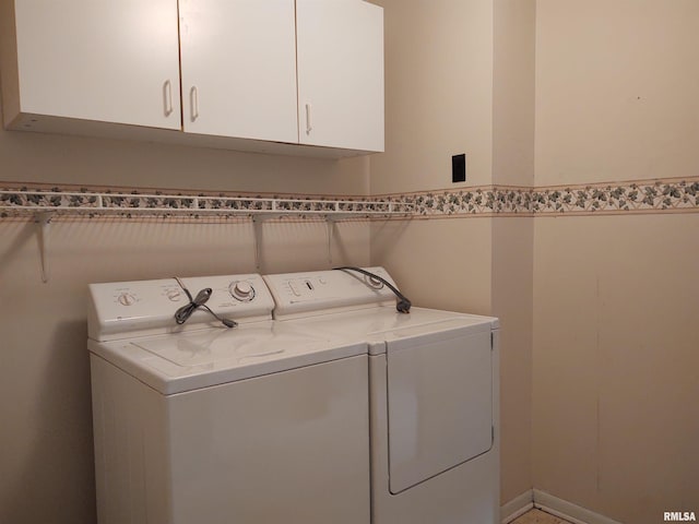 washroom featuring separate washer and dryer and cabinets