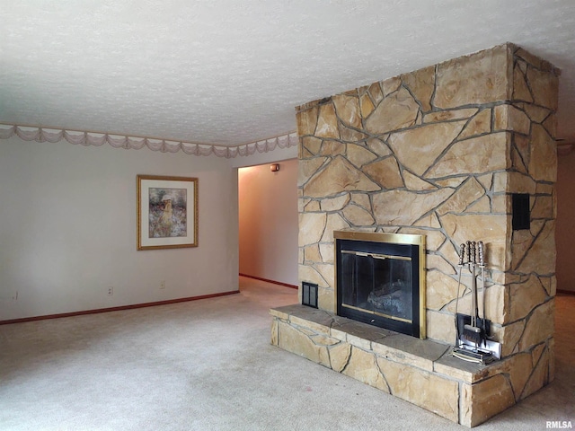 unfurnished living room featuring a stone fireplace, carpet, and a textured ceiling