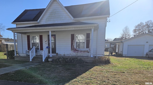 view of front of home with a garage, an outdoor structure, and a front lawn