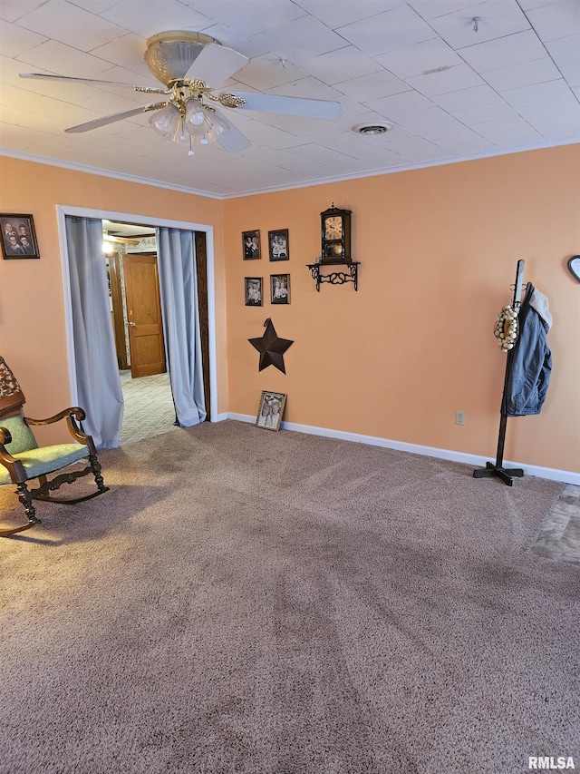 unfurnished room with carpet flooring, ceiling fan, and ornamental molding