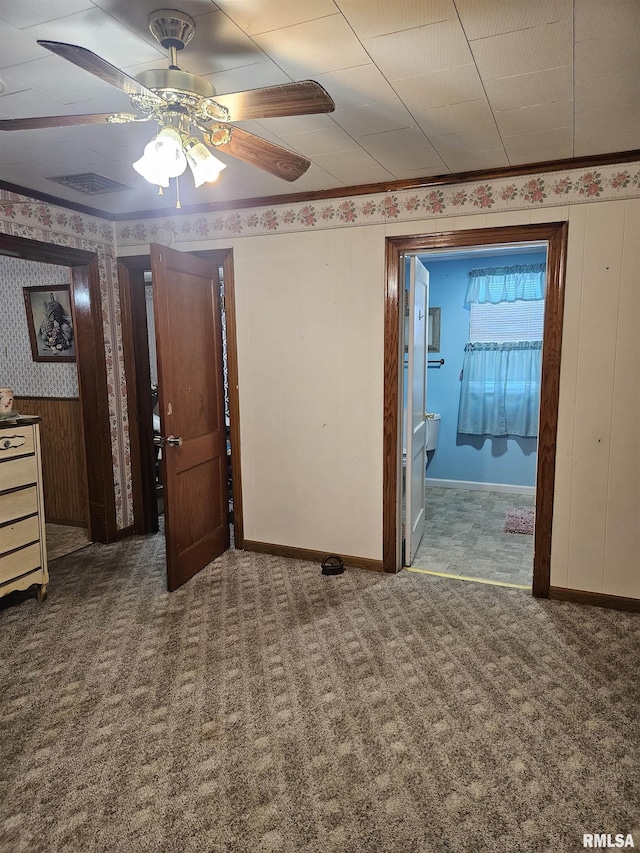 carpeted spare room with ceiling fan