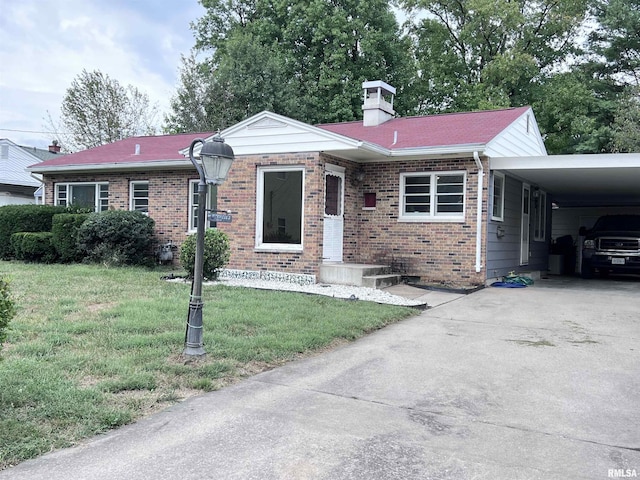 ranch-style house with a front yard and a carport