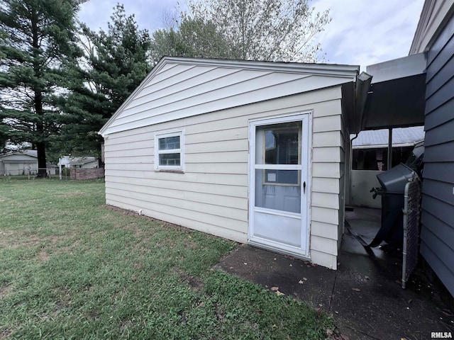 view of outbuilding with a lawn