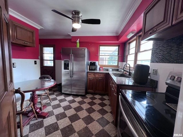 kitchen with dark stone counters, crown molding, sink, ceiling fan, and appliances with stainless steel finishes