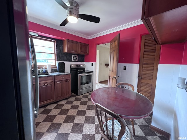 kitchen featuring appliances with stainless steel finishes, tile walls, ornamental molding, and ceiling fan