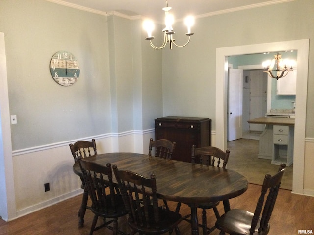 dining room featuring a chandelier, hardwood / wood-style flooring, and ornamental molding