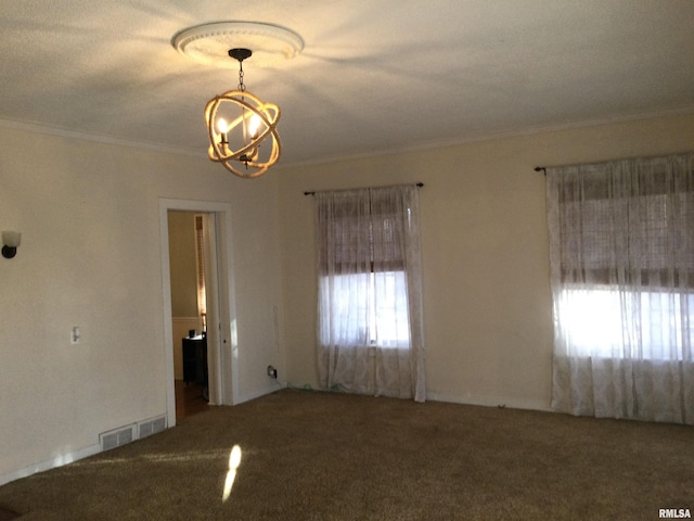 carpeted spare room with a chandelier, a textured ceiling, and crown molding